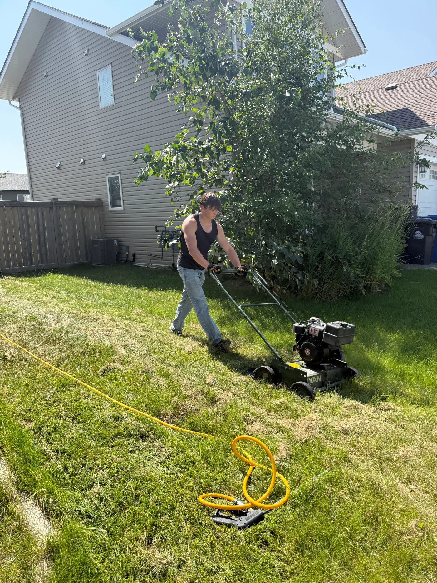 The Dead Weed crew working on a local lawn